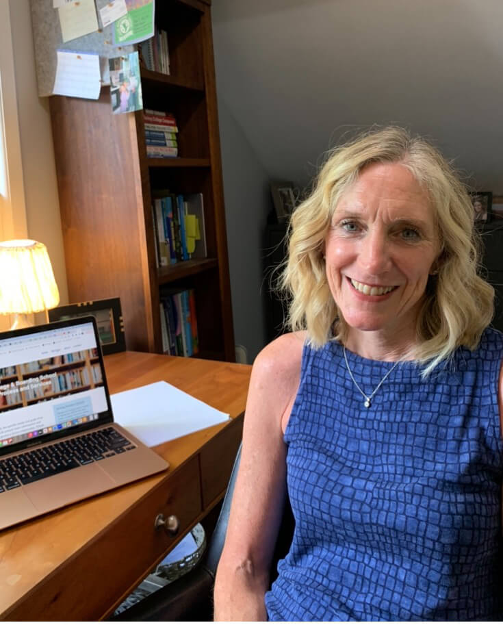 Heather Hyslop smiling while sitting in her office